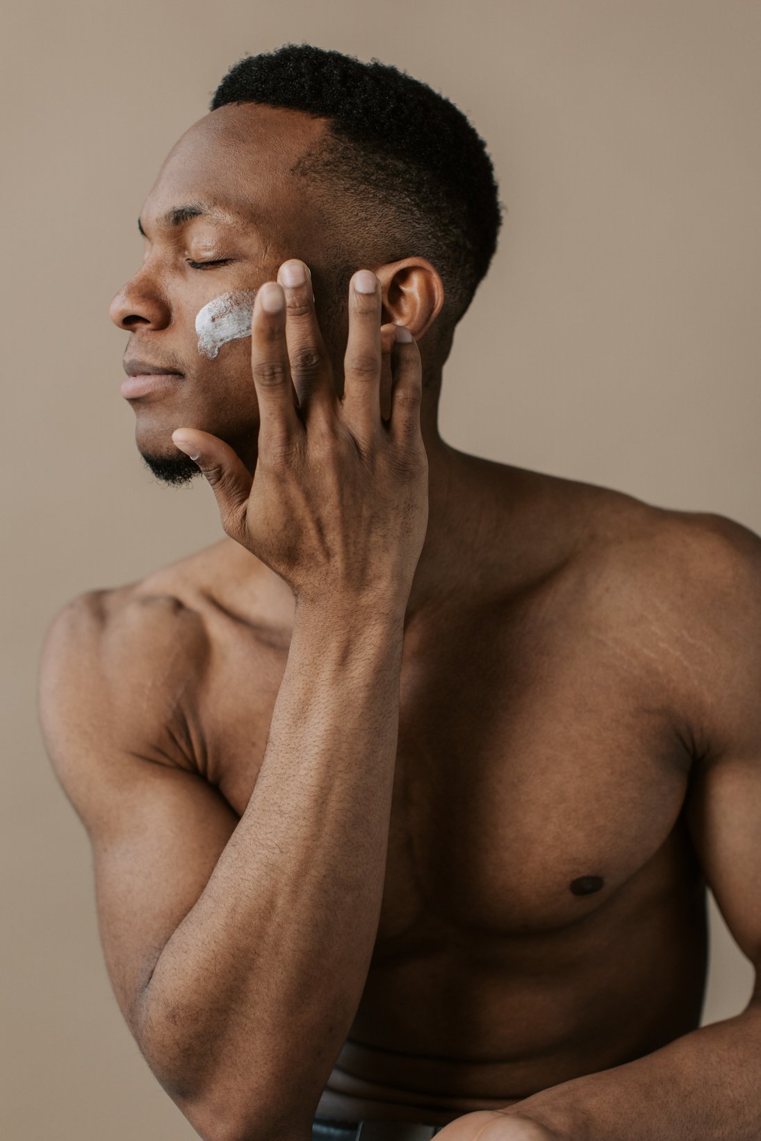 Man Applying Foam Cleanser on Face